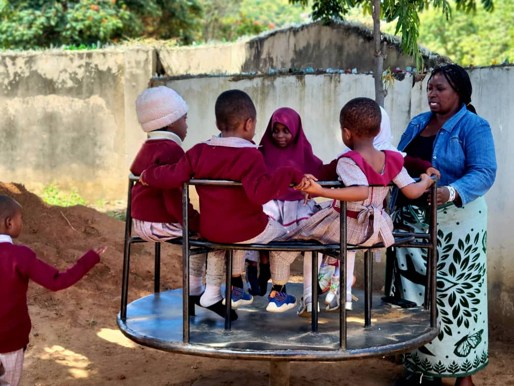 Children playing with activity equipment at SHALOM Day Care